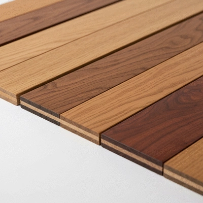 Assortment of high-quality hardwood flooring samples on a white surface